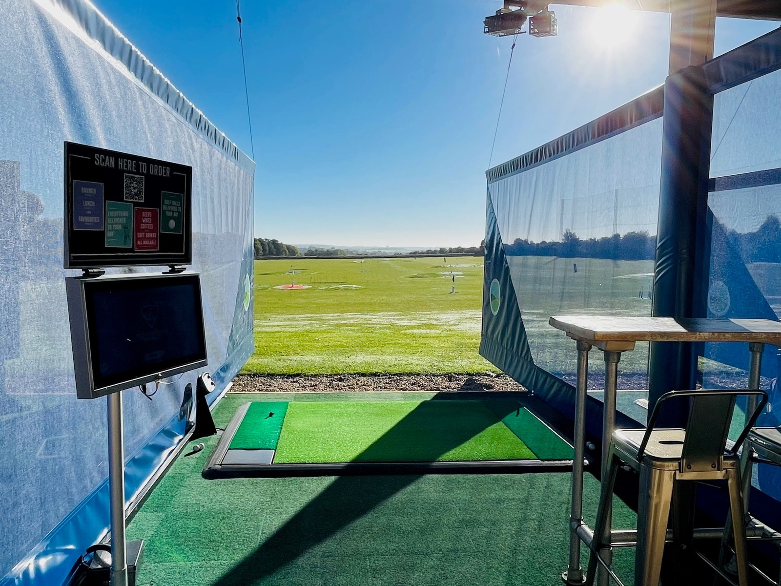 Inside a heated Toptracer bay at Winchester Golf Academy